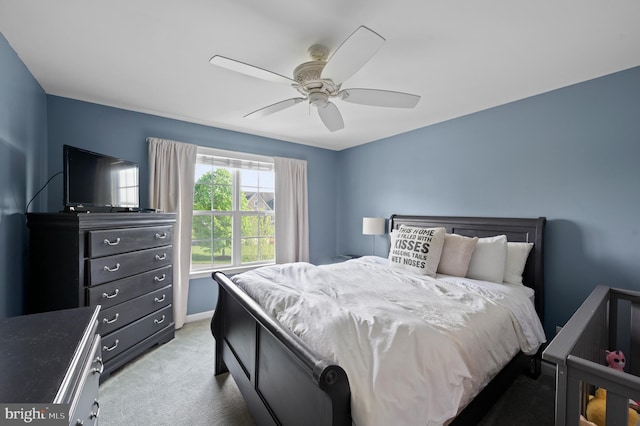 bedroom featuring light carpet and a ceiling fan