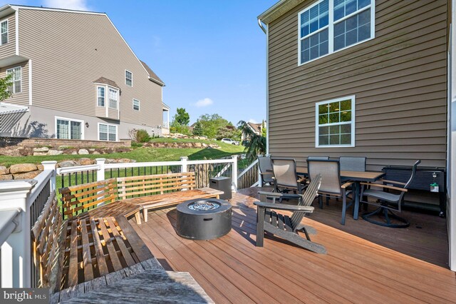deck featuring a fire pit and outdoor dining space