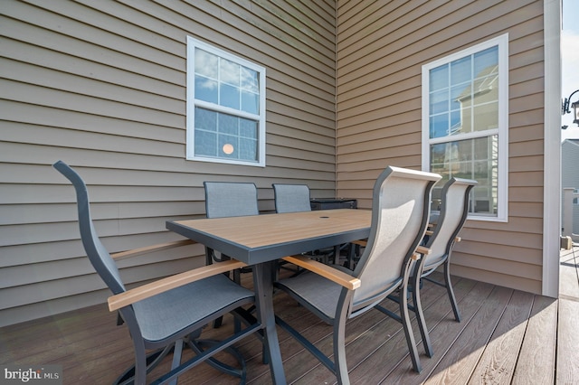wooden deck featuring outdoor dining area