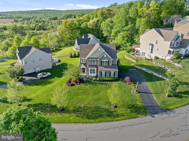view of subject property with a heavily wooded area