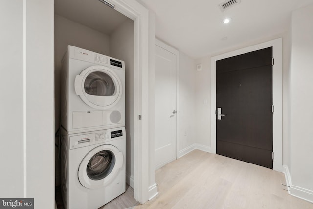 1427 Rhode Island Ave NW Unit L01, Washington, DC 20005 - laundry room with stacked washer / drying machine, wood finished floors, and baseboards