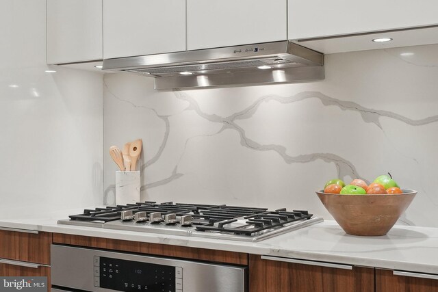 1427 Rhode Island Ave NW Unit L01, Washington, DC 20005 - kitchen featuring oven, under cabinet range hood, stainless steel gas stovetop, modern cabinets, and brown cabinetry