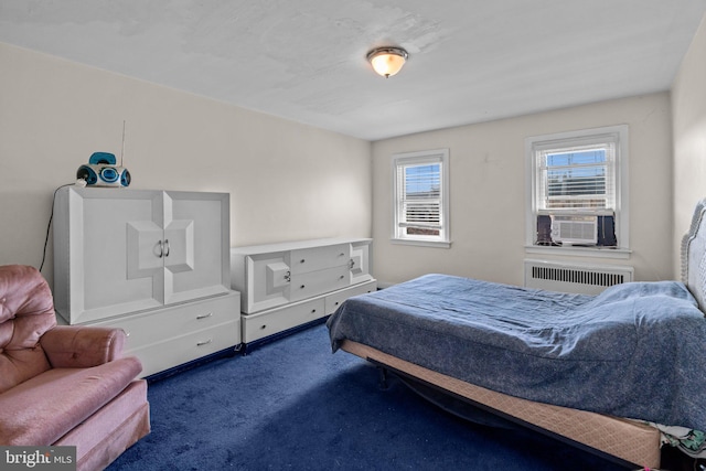 carpeted bedroom with radiator heating unit and cooling unit