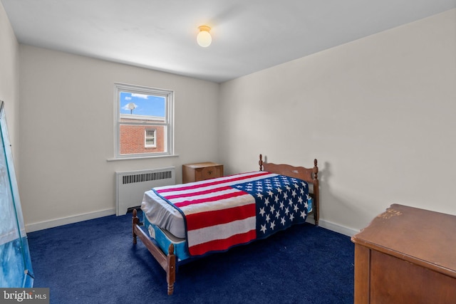 carpeted bedroom with radiator and baseboards