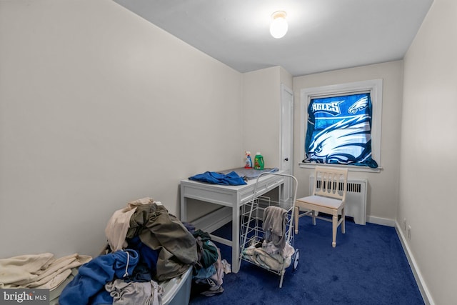 carpeted bedroom featuring baseboards and radiator