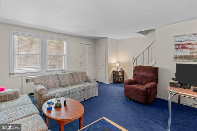 living area featuring stairway, carpet flooring, radiator heating unit, and baseboards