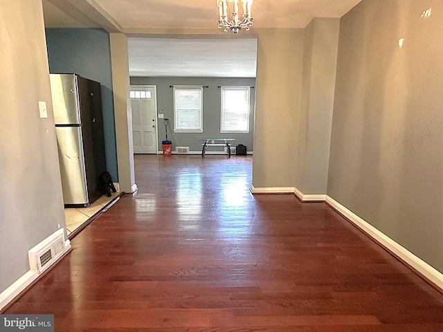 1206 Cedarcroft Rd, Baltimore, MD 21239 - hall featuring wood finished floors, a chandelier, and baseboards