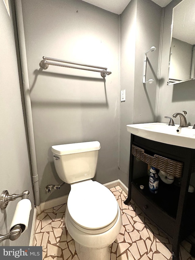 1206 Cedarcroft Rd, Baltimore, MD 21239 - bathroom with toilet, vanity, baseboards, and tile patterned floors