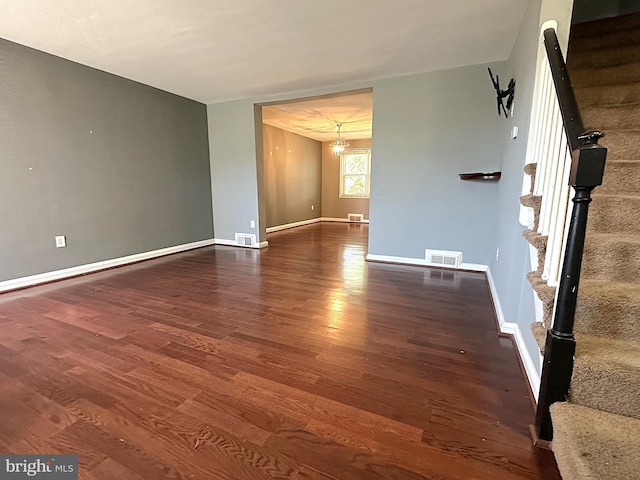 1206 Cedarcroft Rd, Baltimore, MD 21239 - empty room with stairs, wood finished floors, baseboards, and a chandelier