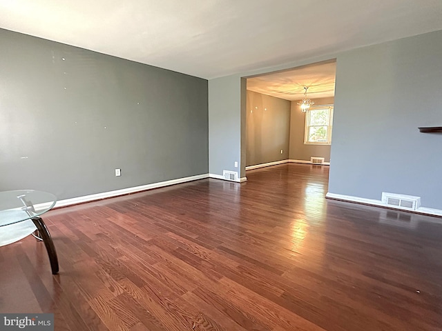 1206 Cedarcroft Rd, Baltimore, MD 21239 - empty room featuring a chandelier, wood finished floors, and baseboards