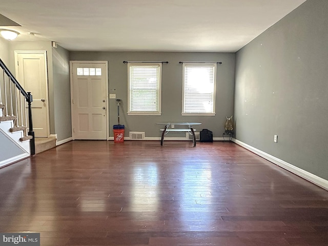 1206 Cedarcroft Rd, Baltimore, MD 21239 - entryway featuring stairs, dark wood-type flooring, and baseboards