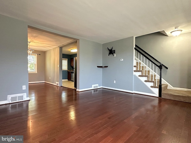 1206 Cedarcroft Rd, Baltimore, MD 21239 - unfurnished living room with wood finished floors, stairs, baseboards, and a chandelier