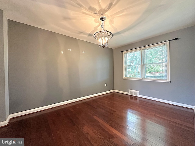 1206 Cedarcroft Rd, Baltimore, MD 21239 - empty room featuring a chandelier, dark wood-style floors, and baseboards