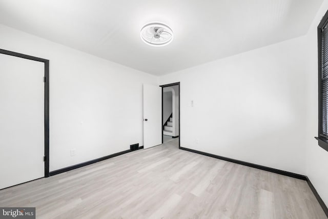 unfurnished bedroom with light wood finished floors and baseboards
