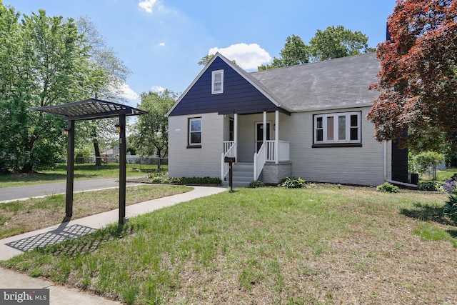 view of front facade with a front yard and brick siding