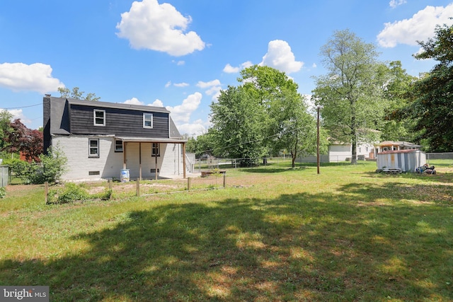 rear view of property featuring a chimney