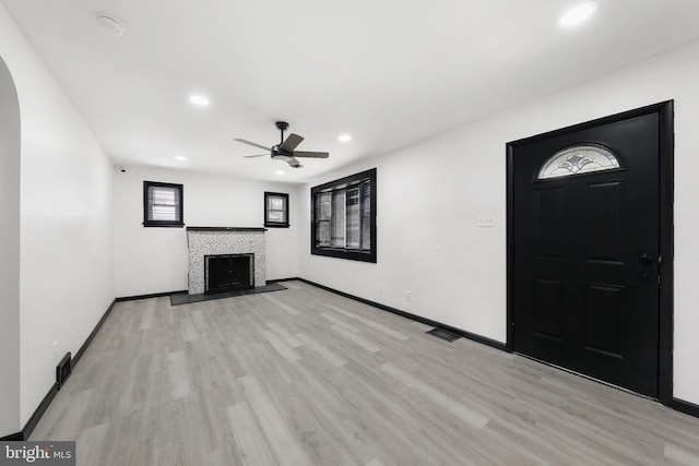 unfurnished living room with a ceiling fan, light wood-style floors, baseboards, and recessed lighting