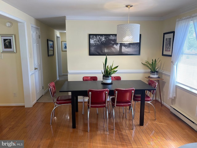 99 Exeter Ct, Shepherdstown, WV 25443 - dining room with baseboard heating, wood-type flooring, baseboards, and ornamental molding