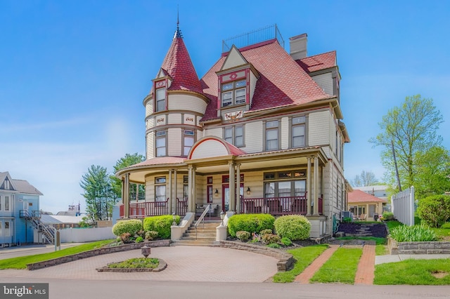301 Meyers Ave, Meyersdale, PA 15552 - victorian home with covered porch, stairs, and a chimney