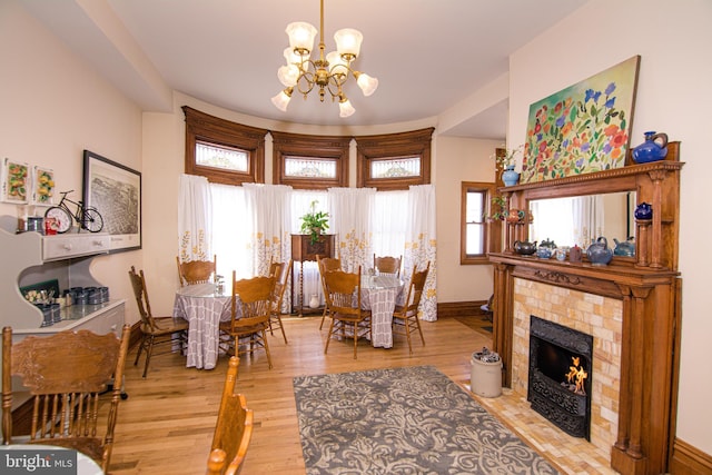 301 Meyers Ave, Meyersdale, PA 15552 - dining room with a chandelier, wood finished floors, baseboards, and a tiled fireplace