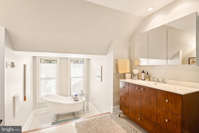 301 Meyers Ave, Meyersdale, PA 15552 - bathroom featuring baseboards, vaulted ceiling, a soaking tub, vanity, and tile patterned flooring