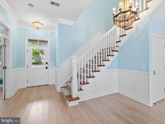 27173 Barefoot Blvd Unit 15, Millsboro, DE 19966 - entryway with a chandelier, wainscoting, wood-type flooring, stairs, and crown molding