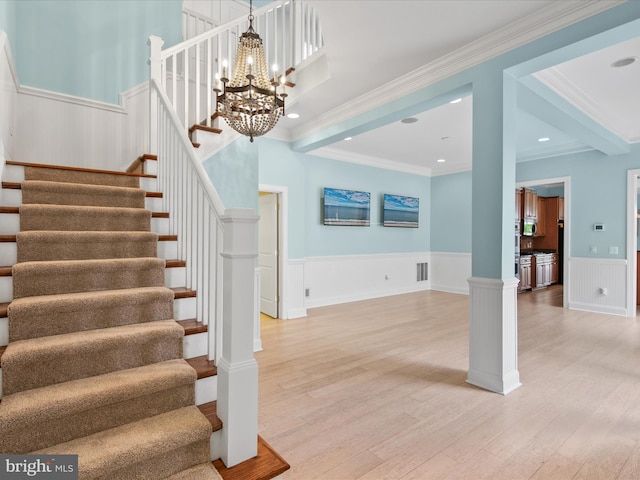 27173 Barefoot Blvd Unit 15, Millsboro, DE 19966 - stairs with a chandelier, wood finished floors, a wainscoted wall, ornamental molding, and recessed lighting