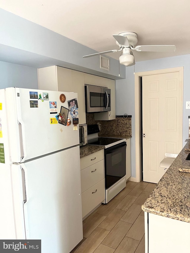 5 Coliston Rd Unit C, Reisterstown, MD 21136 - kitchen with freestanding refrigerator, stainless steel microwave, electric stove, a ceiling fan, and decorative backsplash