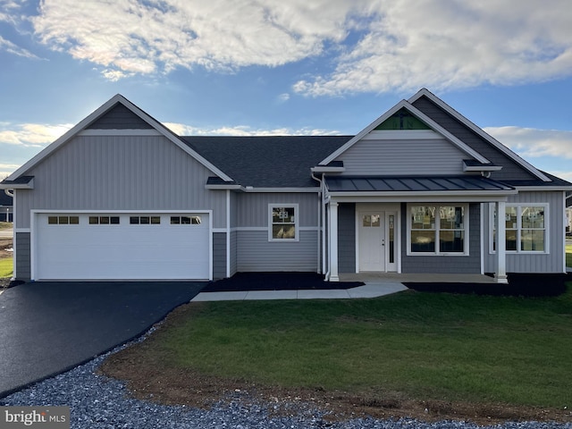 82 S Village Cir Unit 238, Palmyra, PA 17078 - view of front of house with a standing seam roof, driveway, a garage, a front lawn, and metal roof