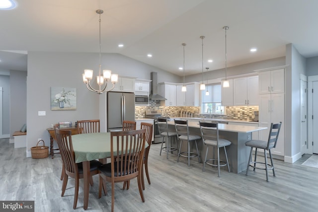 82 S Village Cir Unit 238, Palmyra, PA 17078 - dining space featuring a chandelier, vaulted ceiling, light wood-type flooring, recessed lighting, and baseboards