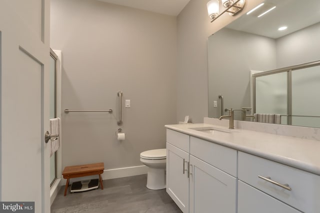 82 S Village Cir Unit 238, Palmyra, PA 17078 - full bathroom with toilet, baseboards, a shower stall, vanity, and wood finished floors