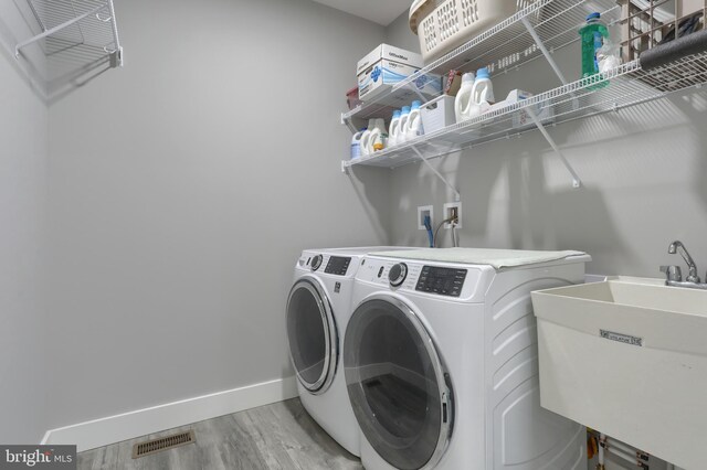 82 S Village Cir Unit 238, Palmyra, PA 17078 - laundry room with light wood finished floors, washer and dryer, and baseboards
