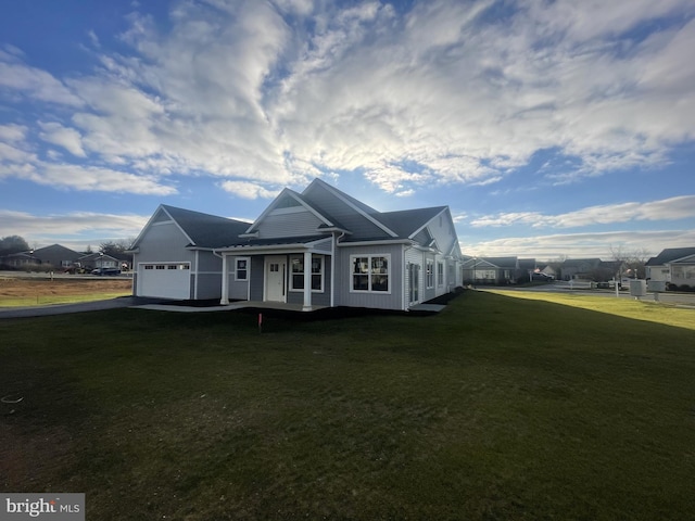 82 S Village Cir Unit 238, Palmyra, PA 17078 - rear view of property with an attached garage, a yard, asphalt driveway, and board and batten siding
