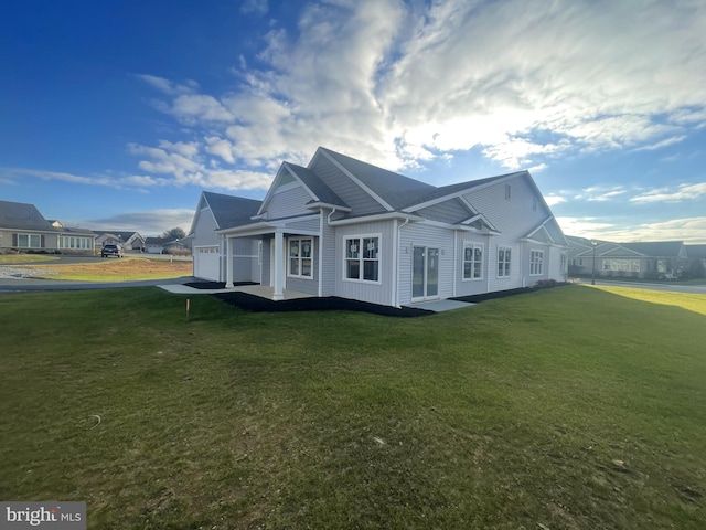 82 S Village Cir Unit 238, Palmyra, PA 17078 - view of side of property featuring an attached garage, a yard, and board and batten siding