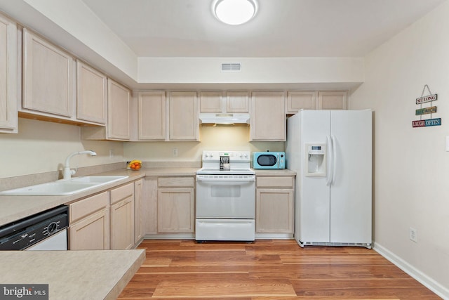 96 High Meadows Dr, Sicklerville, NJ 08081 - kitchen with white appliances, a sink, under cabinet range hood, light countertops, and light wood finished floors