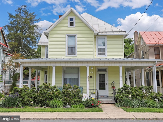 214 Center St, Edinburg, VA 22824 - view of front of house featuring a standing seam roof, covered porch, and metal roof