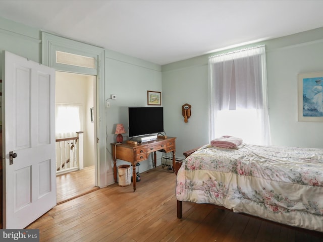 214 Center St, Edinburg, VA 22824 - bedroom featuring light wood-style flooring and a baseboard heating unit