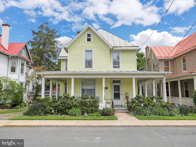 214 Center St, Edinburg, VA 22824 - country-style home featuring a standing seam roof, a porch, and metal roof