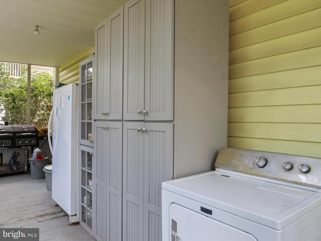 214 Center St, Edinburg, VA 22824 - laundry area featuring washer / dryer, cabinet space, and light wood-style floors