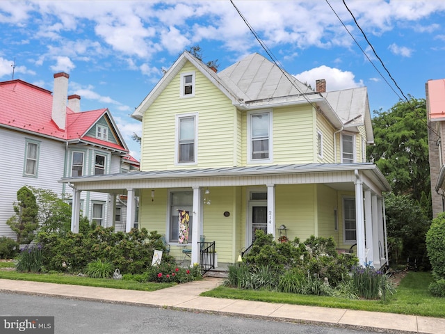 214 Center St, Edinburg, VA 22824 - victorian house with a porch, a standing seam roof, and metal roof