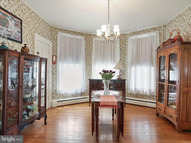 214 Center St, Edinburg, VA 22824 - sitting room featuring wallpapered walls, a baseboard heating unit, a chandelier, wood-type flooring, and plenty of natural light