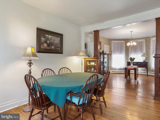 214 Center St, Edinburg, VA 22824 - dining room featuring wallpapered walls, a chandelier, wood-type flooring, baseboards, and decorative columns