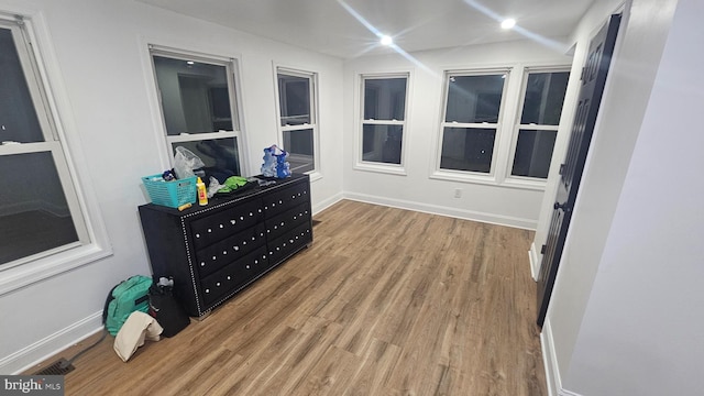 bedroom with wood finished floors and baseboards