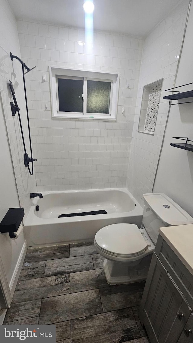 full bathroom featuring toilet, wood finished floors, shower / bathtub combination, and vanity