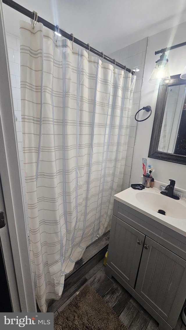 full bathroom with vanity, wood finished floors, and a shower with shower curtain