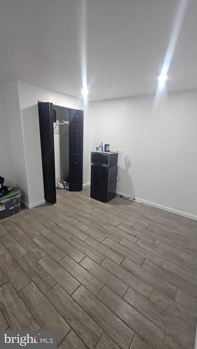 finished below grade area featuring wood finished floors