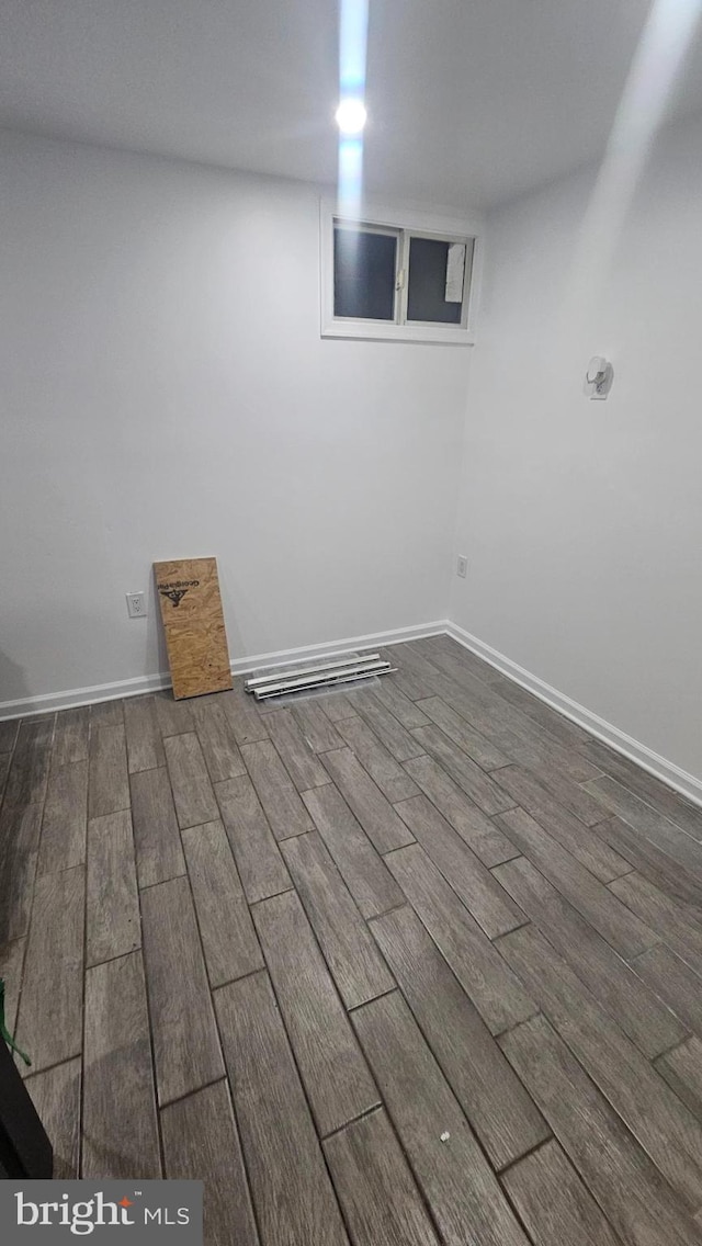 finished below grade area with wood finished floors and baseboards