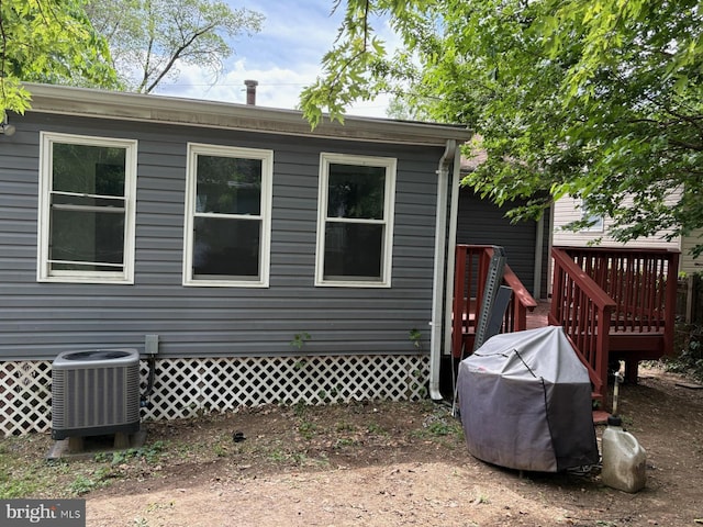 rear view of property with central air condition unit and a deck