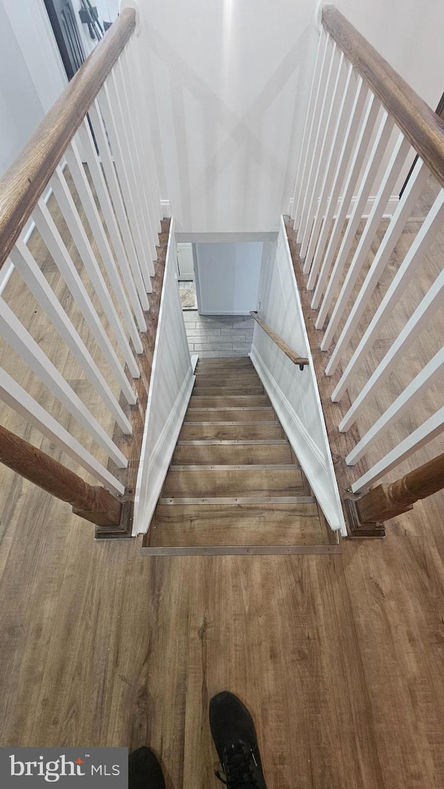 stairs featuring wood finished floors