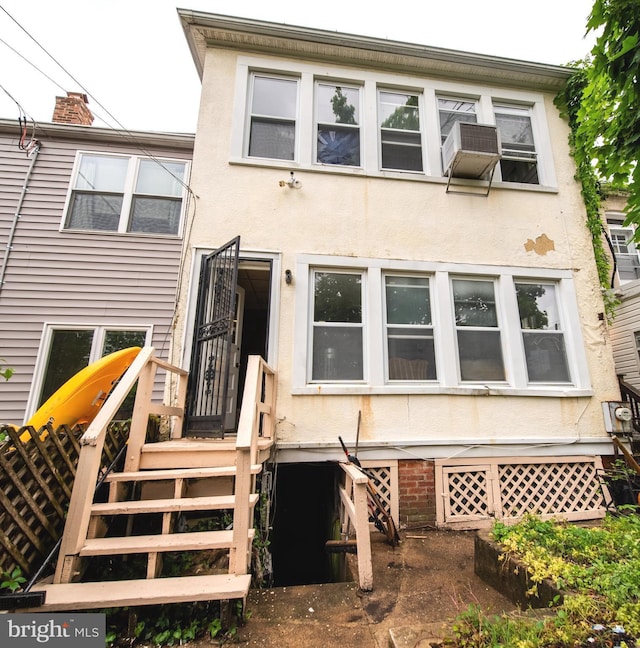 back of property featuring stucco siding